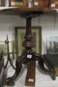 A carved mahogany occasional table