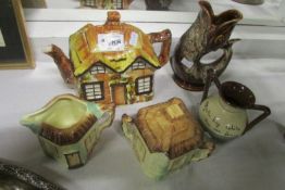 A cottage ware teapot, milk jug & sugar bowl, a fish jug and a mottoware pot