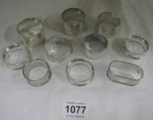 9 silver napkin rings and one other