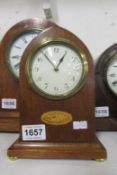 A mahogany inlaid mantel clock