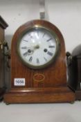 An oak inlaid mantel clock