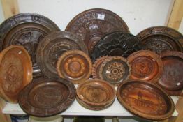 A mixed lot of carved wood plates and bowls
