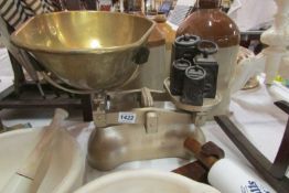 A set of scales with brass pan and steel weights