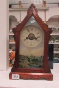 A mantel clock with mountain scene