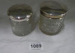 2 silver topped glass jars