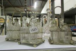 3 4 bottle cruets, a jam pot on stand and a glass jug