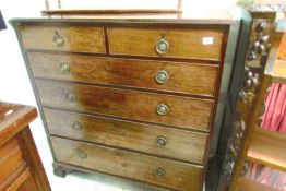 A 2 over 4 mahogany chest of drawers with brass handles