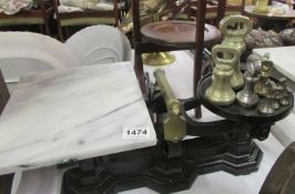 A set of scales with marble tray and brass weights