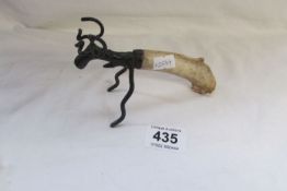 A novelty moose bottle opener with antler handle