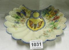 An early 3 footed Delft dish decorated butterfly