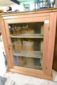 A pine glazed bookcase