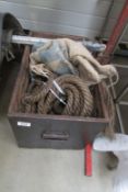 A wooden box containing feed sacks and old rope