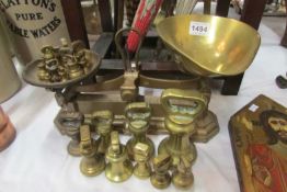 A set of brass scales and a collection of brass weights