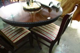 A mahogany effect dining table and 4 chairs