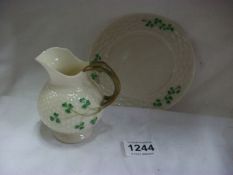 A Belleek cream jug and tea plate (black backstamp) (jug a/f)