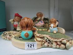 A Pendelfin stand and 4 rabbits