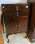 A mahogany music cabinet (front leg a/f)