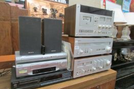 A Yamaha stereo amplifier and tuner, Akia cassette deck, Sony video recorder and a DVD player