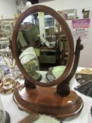 A Victorian mahogany toilet mirror with compartment