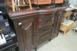 A carved front sideboard