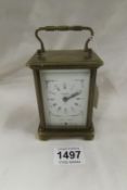 A brass carriage clock (working but door catch missing)