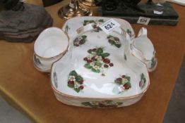 A china strawberry basket with sugar bowl and cream jug