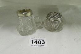 A silver topped trinket pot and a silver rimmed glass item