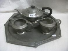 A hammered pewter tea set on tray