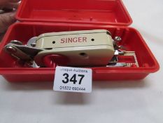 A vintage Singer sewing machine attachment
