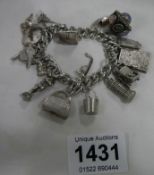 A silver charm bracelet with 18 silver charms (102 gms)