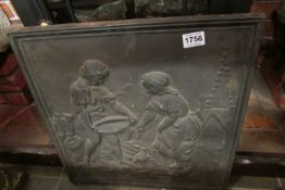 A cast iron wall plaque depicting children