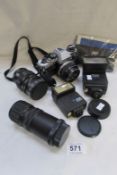 An Olympus camera, lenses, flash guns etc