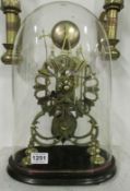 A skeleton clock under glass dome