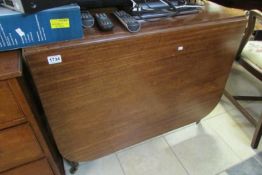 A mahogany drop leaf table