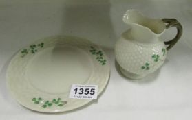 A Belleek plate and jug (jug chipped on spout)
