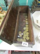 A wooden box containing trade tokens