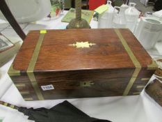 A mahogany brass bound writing box