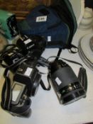 A Minolta Dynax300si camera, Vivitar lens and 2 Canon Eus camera's