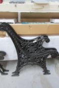 A pair of black cast metal bench ends