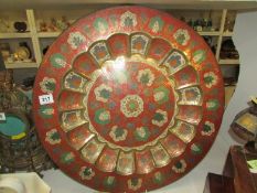A large painted Oriental brass plaque