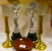 A pair of brass candlesticks, pair of Deco figure and tape measure