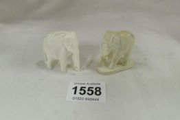 2 carved ivory elephants