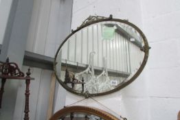 A metal framed oval bevel edged mirror