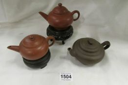 3 Chinese teapots and 2 stands