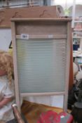 A vintage glass wash board