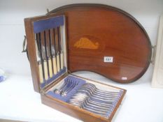 A kidney shaped tray with shell inlay and a small canteen of cutlery