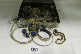 A quantity of costume jewellery in butterfly tin