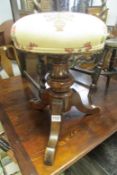 A Victorian revolving piano stool