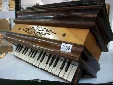 An old wooden piano accordian by Busson, Paris