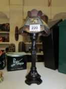 A table lamp with leaded glass shade